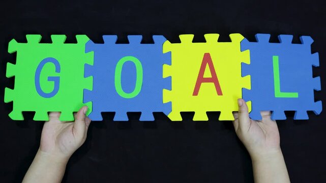 success and achievement concept goal letters on interlocking tiles