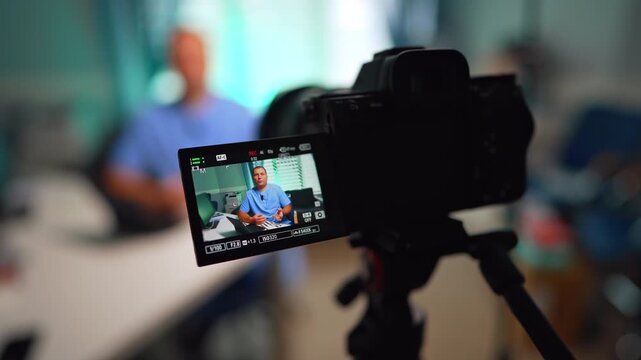 Caucasian male in blue uniform on the camera display. Close up. Medical vlog content creation. Selective focus.