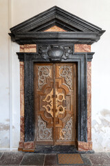 Antique carved solid wood church door with canopy