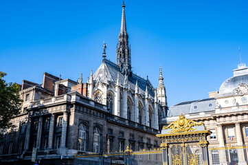 Historic gothic architecture featuring intricate spires and ornate details under a clear blue sky, showcasing timeless craftsmanship and design