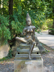 Bronze statue of Parvati goddess in garden setting