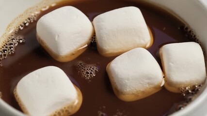 Marshmallows gently melting in hot cocoa, creating a deliciously cozy atmosphere. 4k Video footage - Powered by Adobe