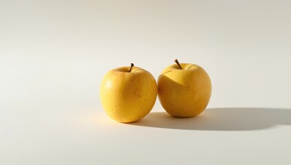 Vibrant simple wild berries - a pair of tiny yellow natural apples on a white backdrop