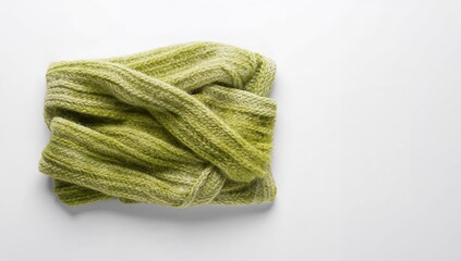 White backdrop showcasing a green knitted scarf
