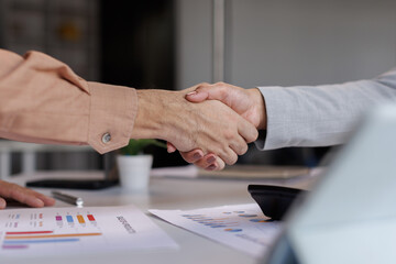 Business handshake for teamwork of business merger and acquisition,successful negotiate,hand shake,two businessman shake hand with partner to celebration partnership and business deal concept