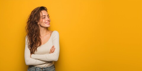 Model's head raised and looking forward,smiling,arms crossed,copy space,yellow background,banner