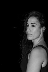 Woman looking over shoulder with hair blowing