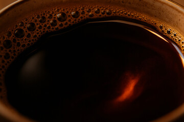 Papua New Guinean single-origin coffee, dark liquid reflecting warm light