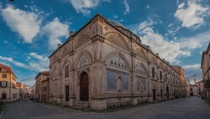 Fototapeta premium Historic stone mosque against a clear blue sky, showcasing architecture and travel vibes