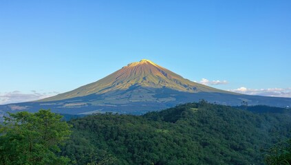Fototapeta premium Majestic Sumbing summit glowing yellow under early sunlight
