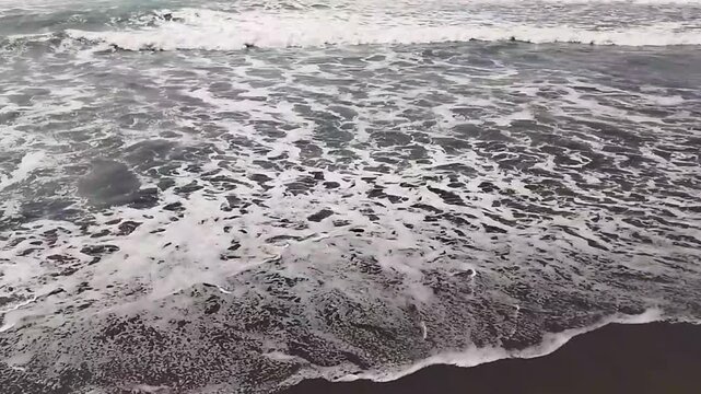 Vast Sea Horizon View with Rough Waves and Moody Sky on Cilacap Beach.

