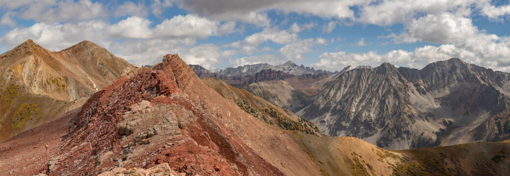 This scenic mountain panorama features the colorful ruby red ridge of Avery Peak with a stunning background of Elk Range Mountains near Crested Butte, Colorado.