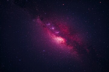 Fototapeta premium A sudden burst of light against a dark sky with sparkling stars and a vivid crimson galaxy