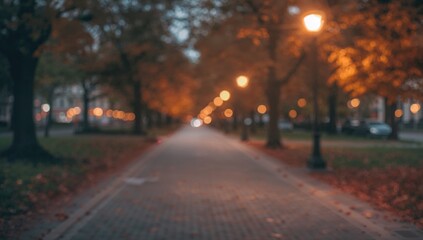 Soft Focus Autumn Evening Scene in a Tranquil Park Featuring a Cobblestone Path and Cozy Street Lamps