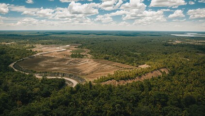 Bird's-eye perspective of gold extraction site in dense tropical rainforest
