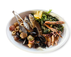 a plate of seafood and vegetables on a white background