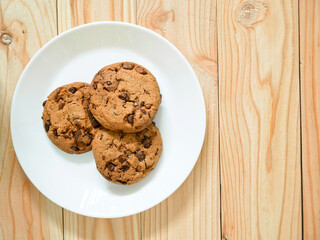 Chocolate chip cookies on wooden background