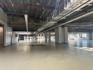 Empty Industrial space for production floor or warehouse space. Vacant production facility. Warm shell with windows. Renovation industrial unit.