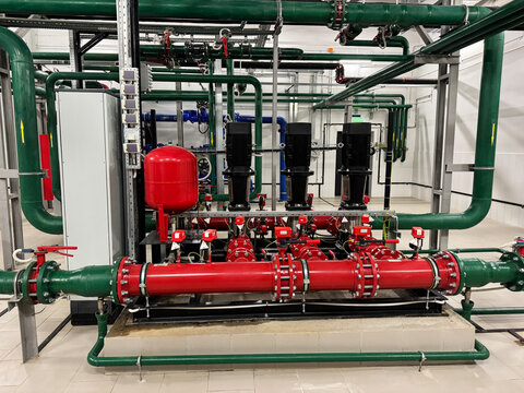 Industrial boiler plant, heating system. System is equipped with various instruments, including pressure gauges, temperature sensors, and flow meters, all connected to central control panel.