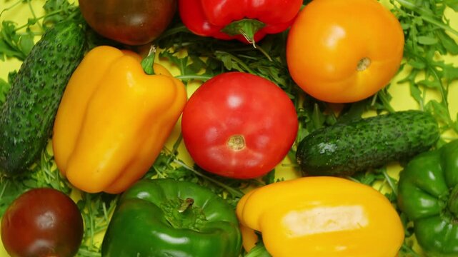 Set of various vegetables flat lay, 360 degrees rotation. Tomato, pepper and cucumber on yellow background, top view. Vegetarian and healthy food