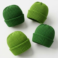 Four green knitted hats isolated on white background