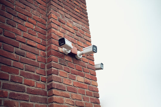 Security camera on the wall of a brick building