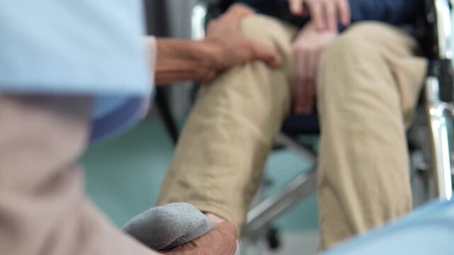 A doctor or physical therapist's examine tremors caused by nervous system activity are being examined, causing inability to control movement are similar to those of patients with Parkinson's disease.