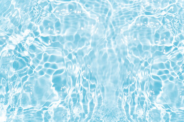 Obraz premium Blue water with ripples on the surface. Defocus blurred transparent blue colored clear calm water surface texture with splashes and bubbles. Water waves with shining pattern texture background.