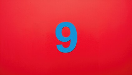 Red backdrop featuring a blue digit nine. Celebration theme. Landscape orientation.