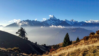 Mountain peaks rise above valley fog on trail, scenic outdoors, travel background