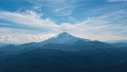 Fototapeta premium Panoramic view of a mountain outline under a cloudy blue sky from above