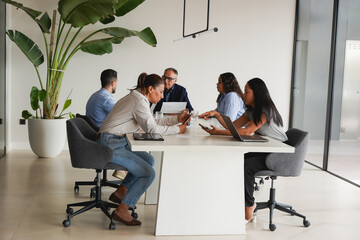 Multiracial colleagues sharing ideas for financial project inside modern office - Multi generational business people, entrepreneurs and corporate concept