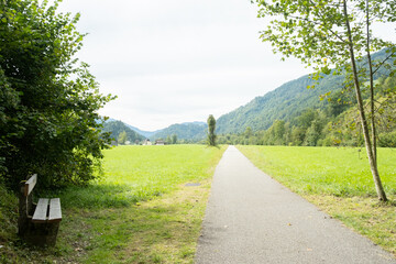 A trail in the mountains and a bench for outdoor recreation