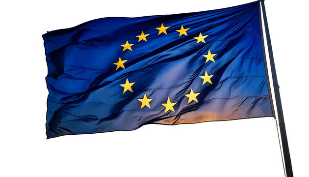 The flag of the european union, with its circle of stars, waving against a sunset white 