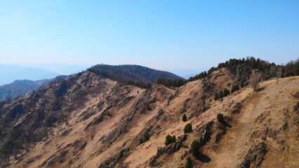 Mountain ridge under clear blue sky in early spring. Media