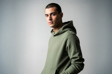 Young man wearing a green hooded sweatshirt