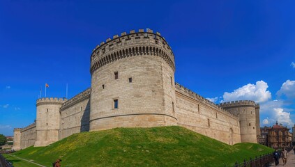 Historic fortress with ancient stone walls under a clear blue sky