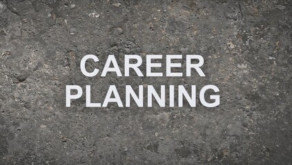 Career development icon on an elegant grey rock surface. Words related to career growth displayed on a smooth brown stone wall. Inspirational business and career strategy theme with ample copy space.