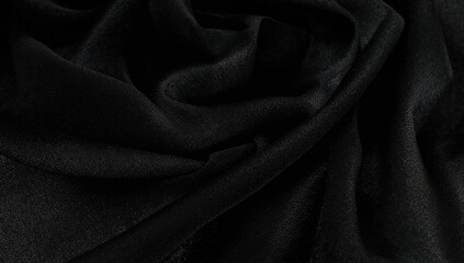 A detailed view of smooth fabric showing delicate folds and shimmering light effects.