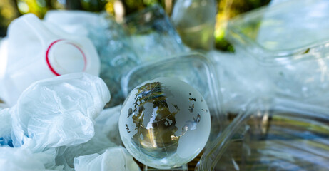 Trash and plastic pollutes near earth planet. Garbage on nature. Caring for Earth preserves the planet.