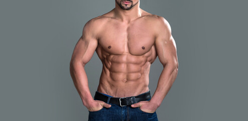 Athletic bodybuilder man on grey background. Banner templates with muscular man, muscular torso,...