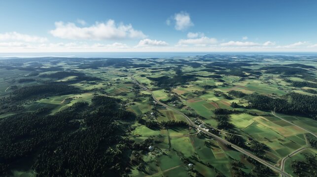 Aerial view of rural landscape with green fields, roads and small villages under clear blue sky