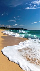 Ocean Waves Crashing on Sandy Beach Under Blue Sky