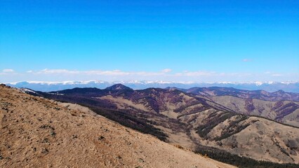 Majestic mountain range under a clear blue sky. Media