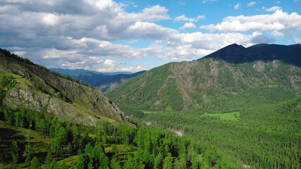 Fototapeta premium Majestic mountain valley panning shot with lush green forest. Media