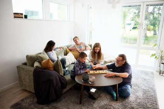 Happy multi-generational family spending leisure time at home