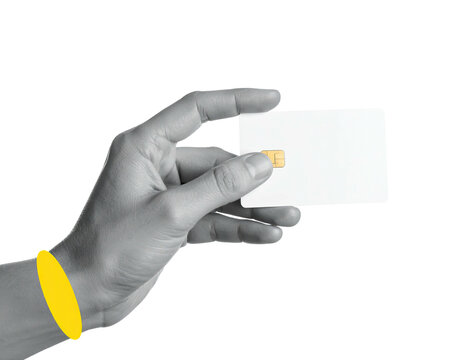 A grayscale hand delicately holds a blank white card with a subtle gold chip