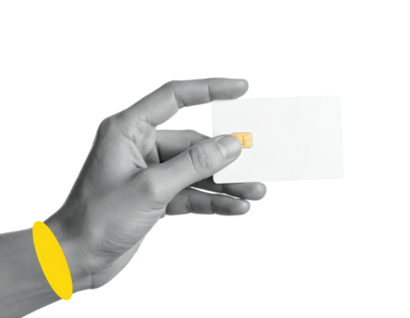 A grayscale hand delicately holds a blank white card with a subtle gold chip