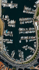 Aerial perpendicular view of the small tourist port called "La Cala" and located in Palermo, Sicily, Italy. There are many boats in the marina overlooking the Mediterranean Sea.
