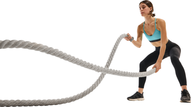 Woman performing battle rope exercise. Concept of strength, determination, fitness motivation expressing endurance, focus, and dynamic movement power. Transparent background